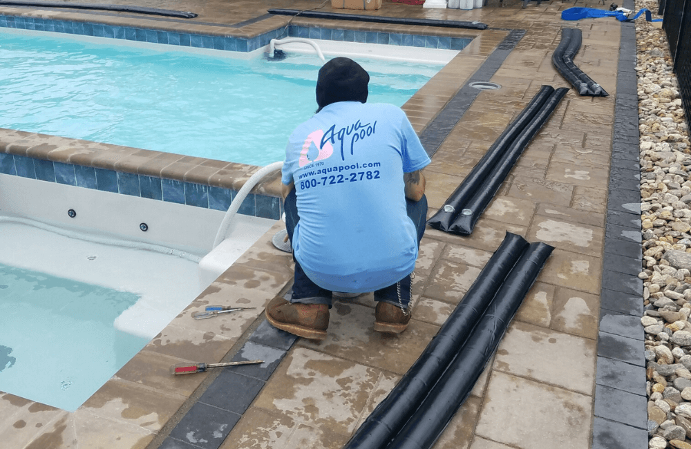 Aqua Pool team member closing a swimming pool